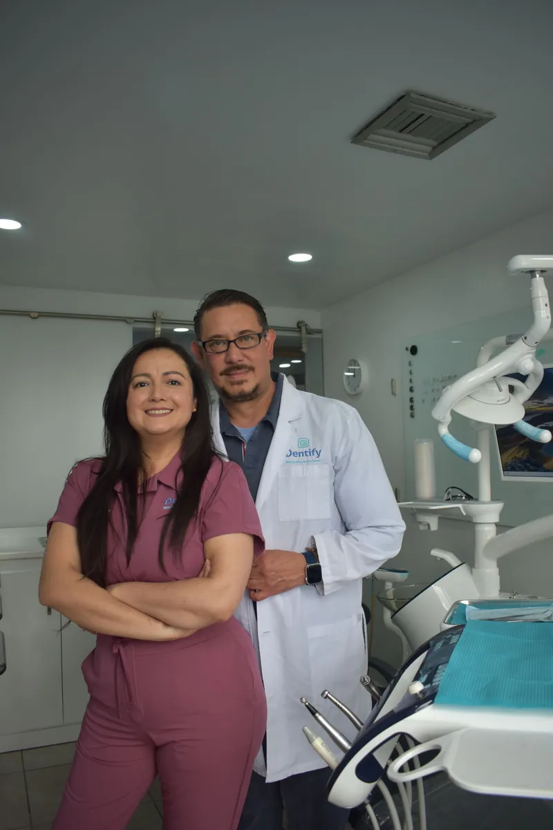 A dentist and his assistant standing in their clinic