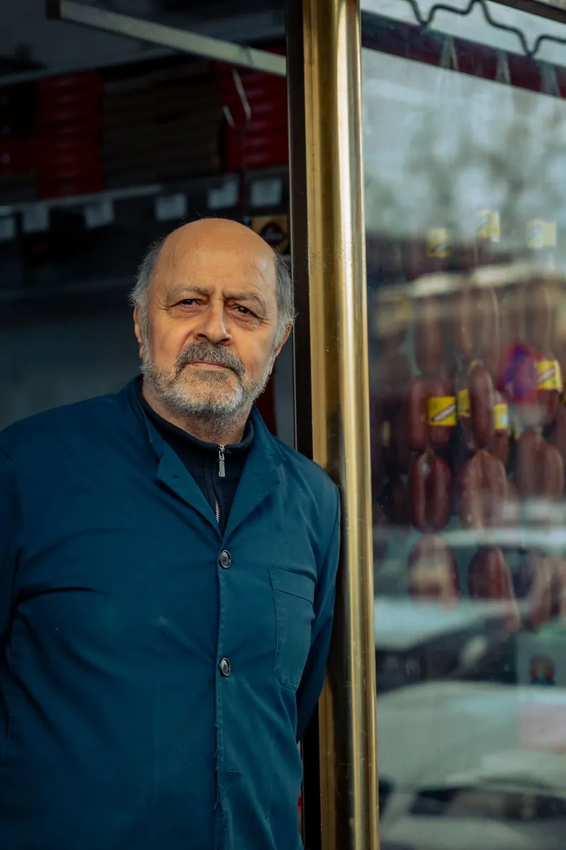 A shop owner standing in the doorway of his store